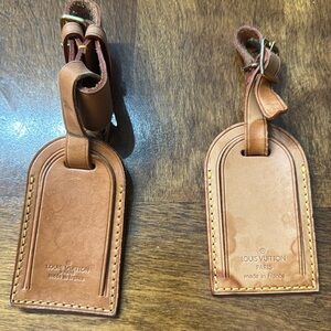 Two Louis Vuitton luggage tags